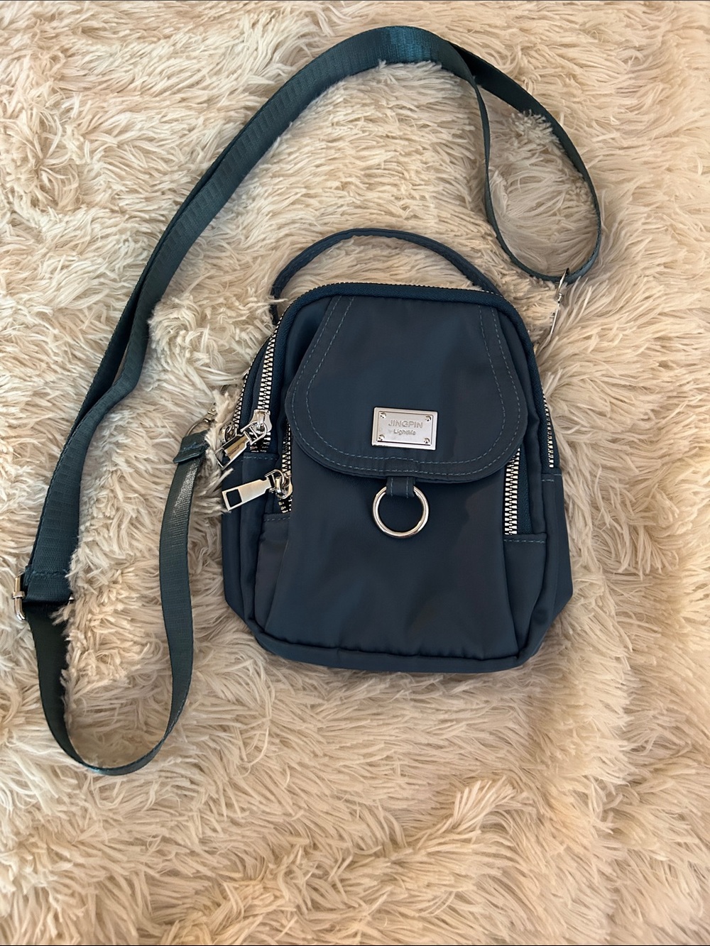 Compact Navy Crossbody Bag with Front Pocket and Ring Detail